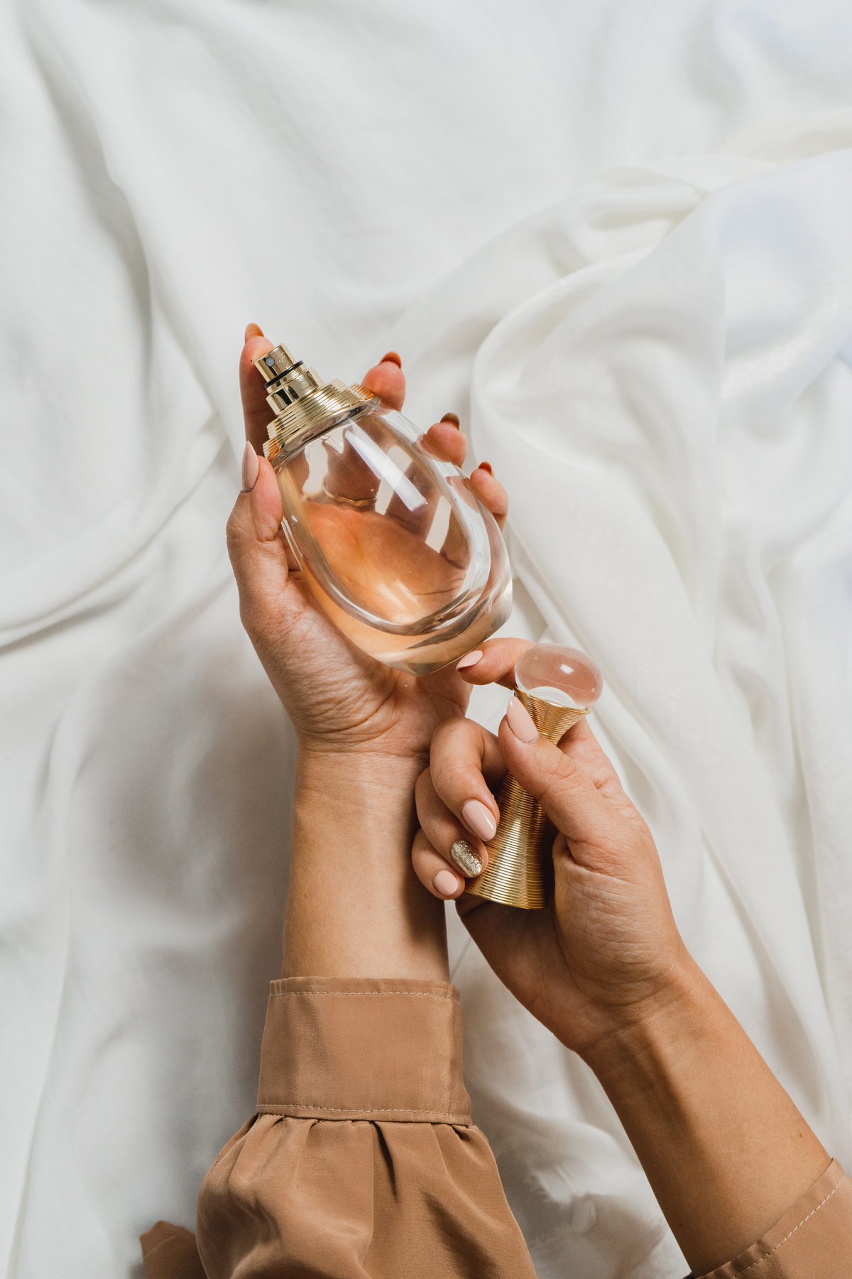 Hand Holding Perfume Bottle